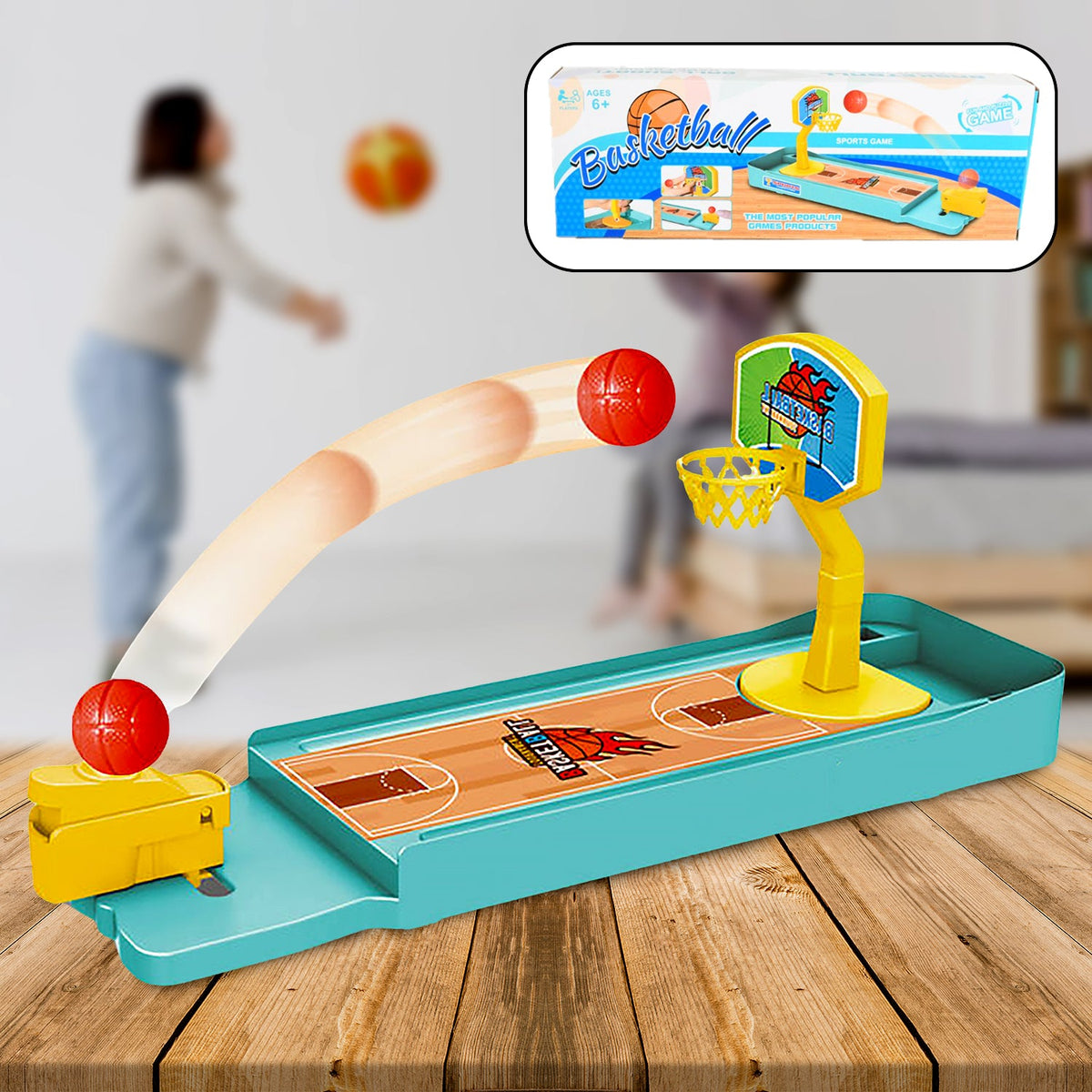 A miniature basketball game on a wooden table, featuring a red ball in motion and a product box in the top right.