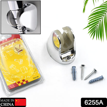 A chrome shower holder and mounting hardware are displayed next to a clear package with a yellow insert and green leaf.