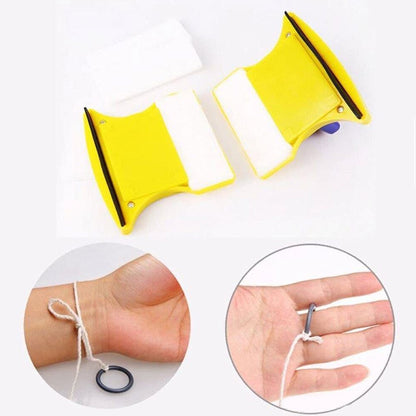 Two halves of the yellow magnetic cleaner with white pads, and hands demonstrating the safety rope.
