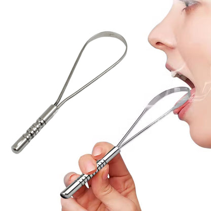 A hand holds a silver metal tongue cleaner near a person's open mouth, with another cleaner beside it.