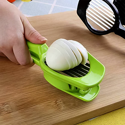 A hand presses down on a green plastic slicer, cutting a hard-boiled egg into multiple thin, even slices.