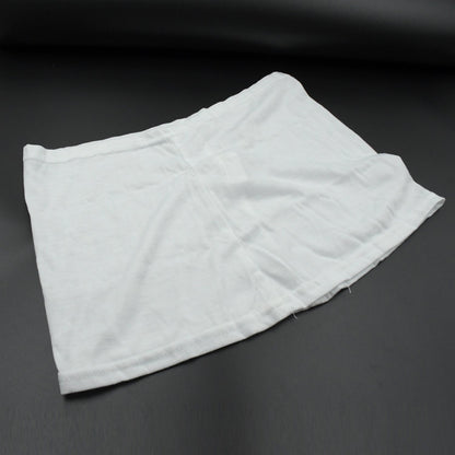 A white layered hip skirt with shorts lies folded on a dark gray surface.