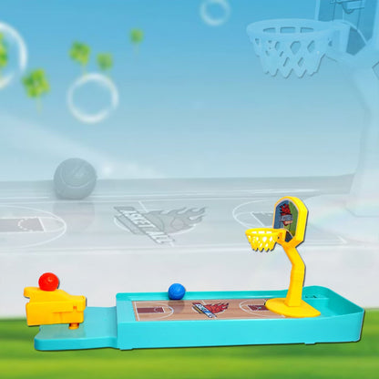 The miniature basketball game on a light blue court background with a blurred, larger basketball hoop in the distance.