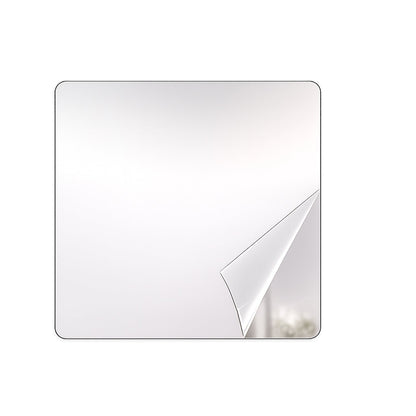 A square mirror with rounded corners has a corner of its protective film peeled back, revealing a reflection.