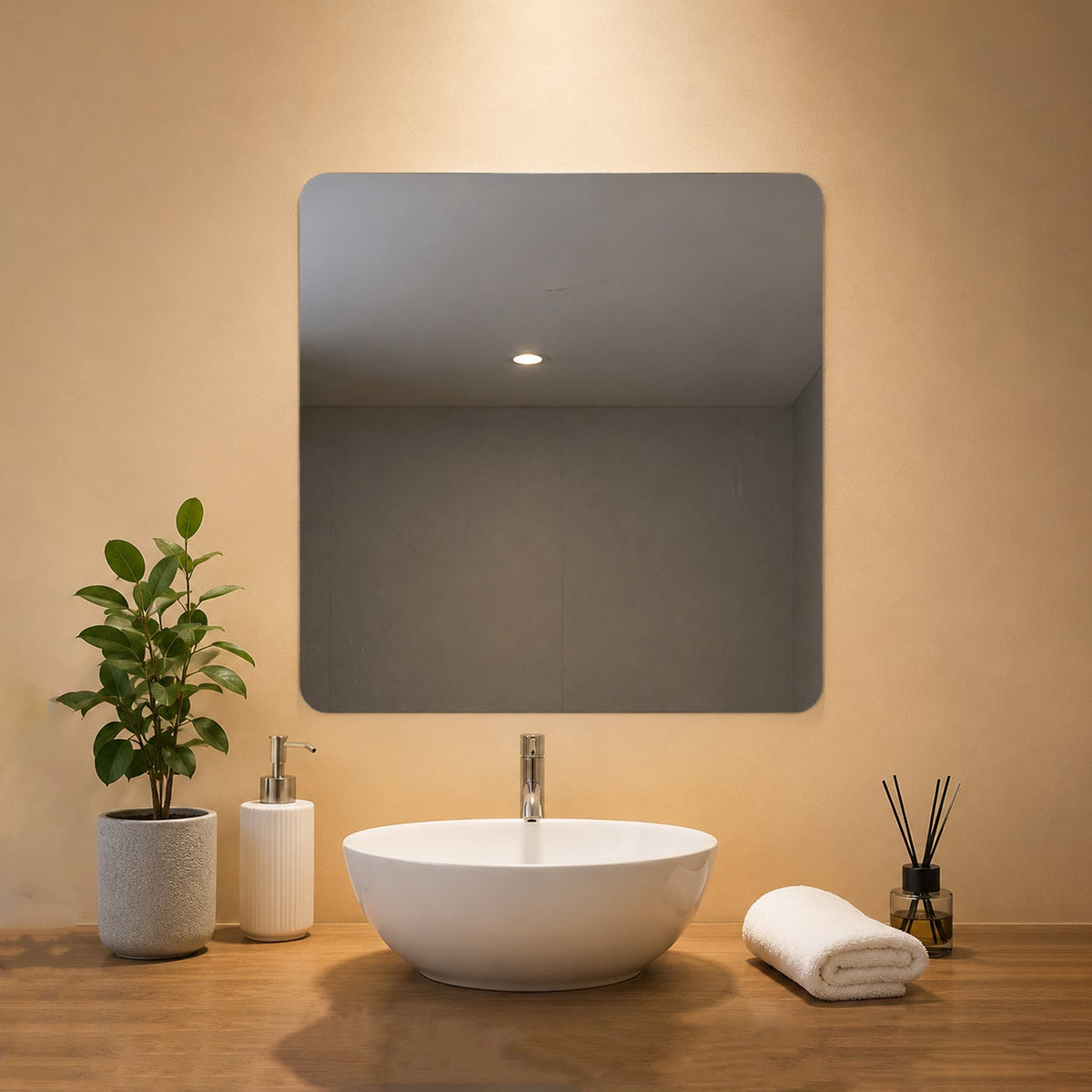 A square mirror with rounded corners hangs above a white sink in a modern bathroom setting.