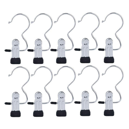 Ten shiny silver metal clip hangers with black rubber tips and S-shaped hooks are arranged in two rows on a white background.