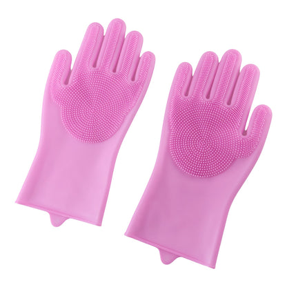 A pair of pink silicone scrubbing gloves with textured palms displayed on a plain white background.