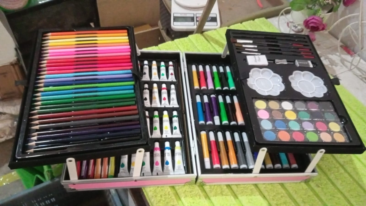 All 145 pieces of the art kit laid out, including markers, pencils, and paints, for a comprehensive view.