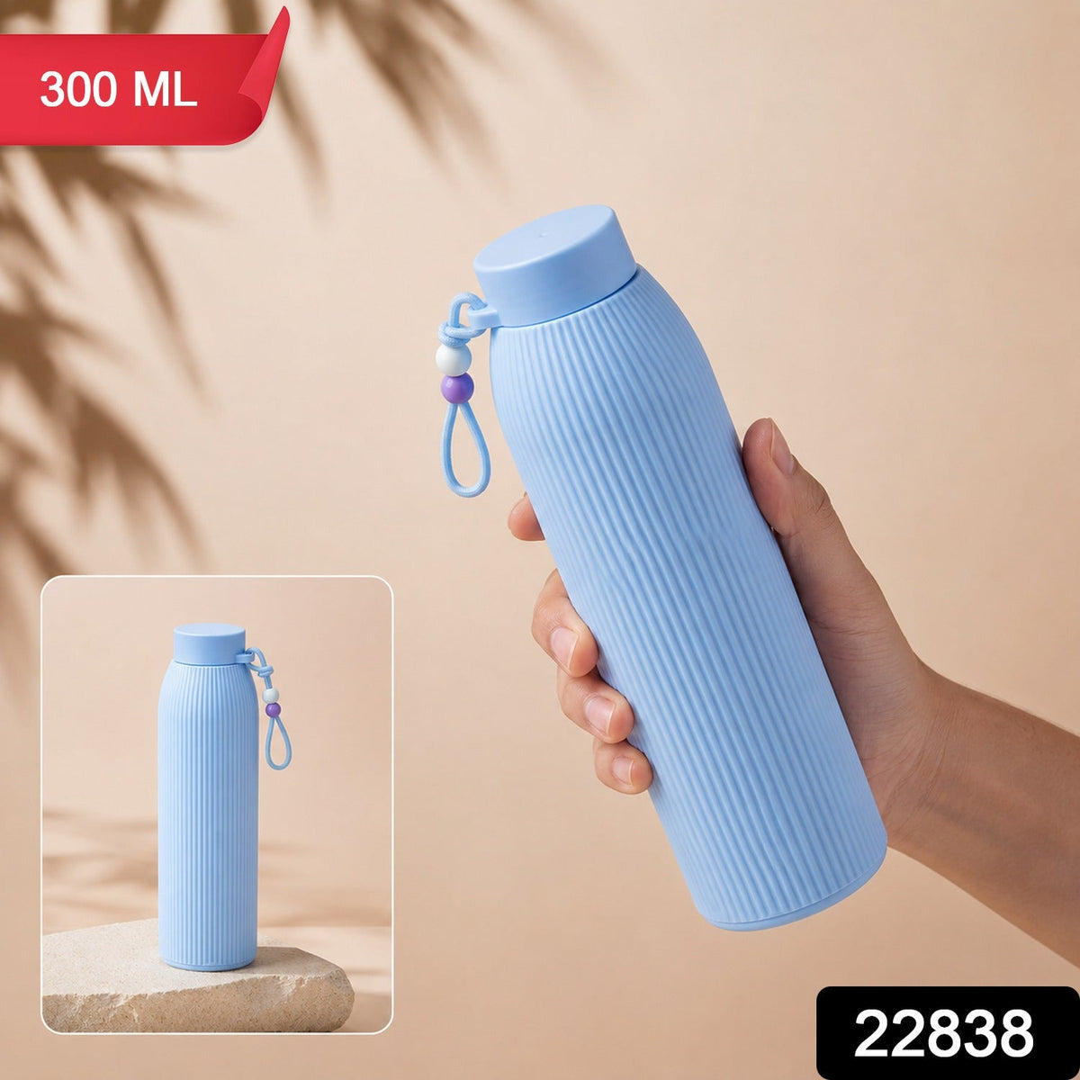 A hand holds a light blue ribbed glass water bottle with a beaded strap, with a smaller inset image showing it on a – view 2