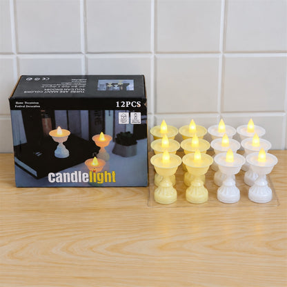 A black box labeled "candlelight" sits next to twelve LED diya candles, six yellow and six white, on a light wooden surface.