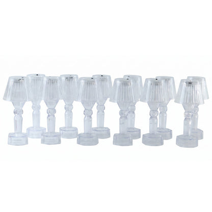 A dozen clear acrylic miniature lamps with ribbed shades are neatly displayed in rows on a plain white background.