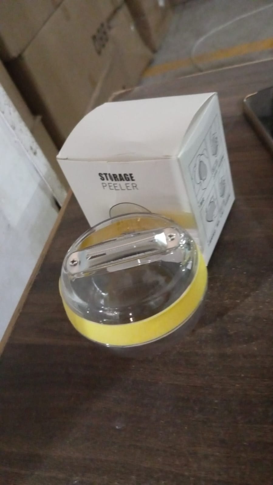 Peeling carrots with the multifunctional round peeler, demonstrating its integrated container.