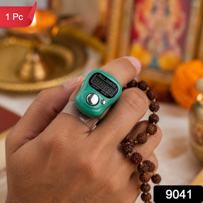A hand holds a green digital tally counter on a finger, with brown prayer beads. A red "1 Pc" label is in the top left
